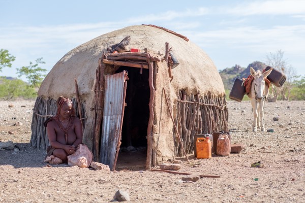 A Himba woman shelters from Namibia's extreme heat