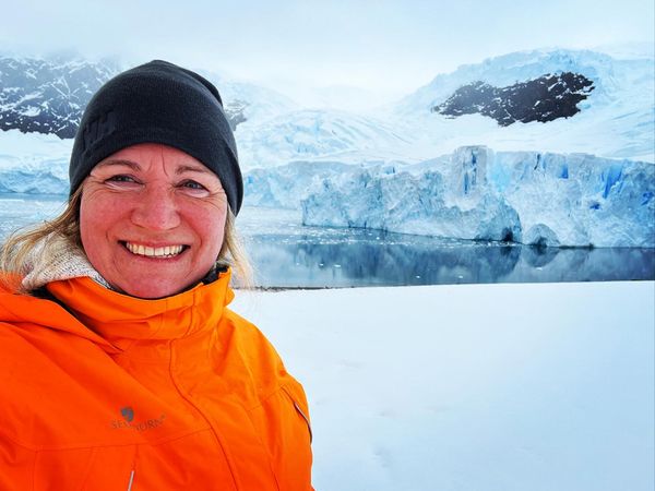 A Danish traveller Mette Ehlers Mikkelsen posing in front of the glacier in Antarctica. She is one of the travellers who are waiting for North Korea to open to finish all UN193 countries.