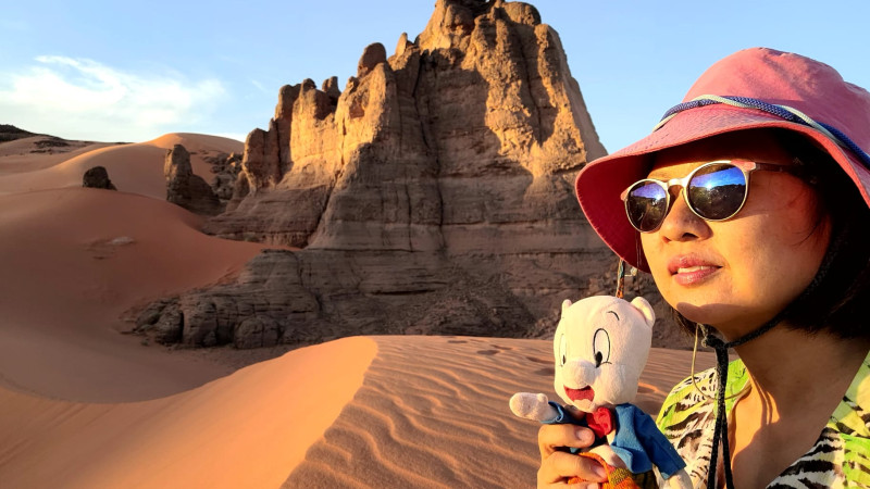 Ernestine posing with her Porky Pig in Algerian desert