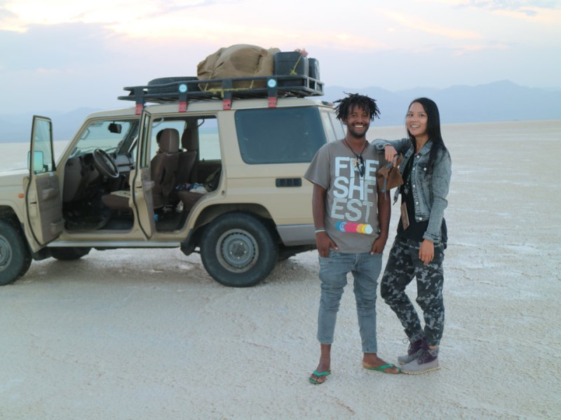 Sabrina Zhang and her travel buddy posing in front of a car during a road trip.
