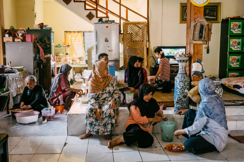 A group of Muslim women sitting inside a house
