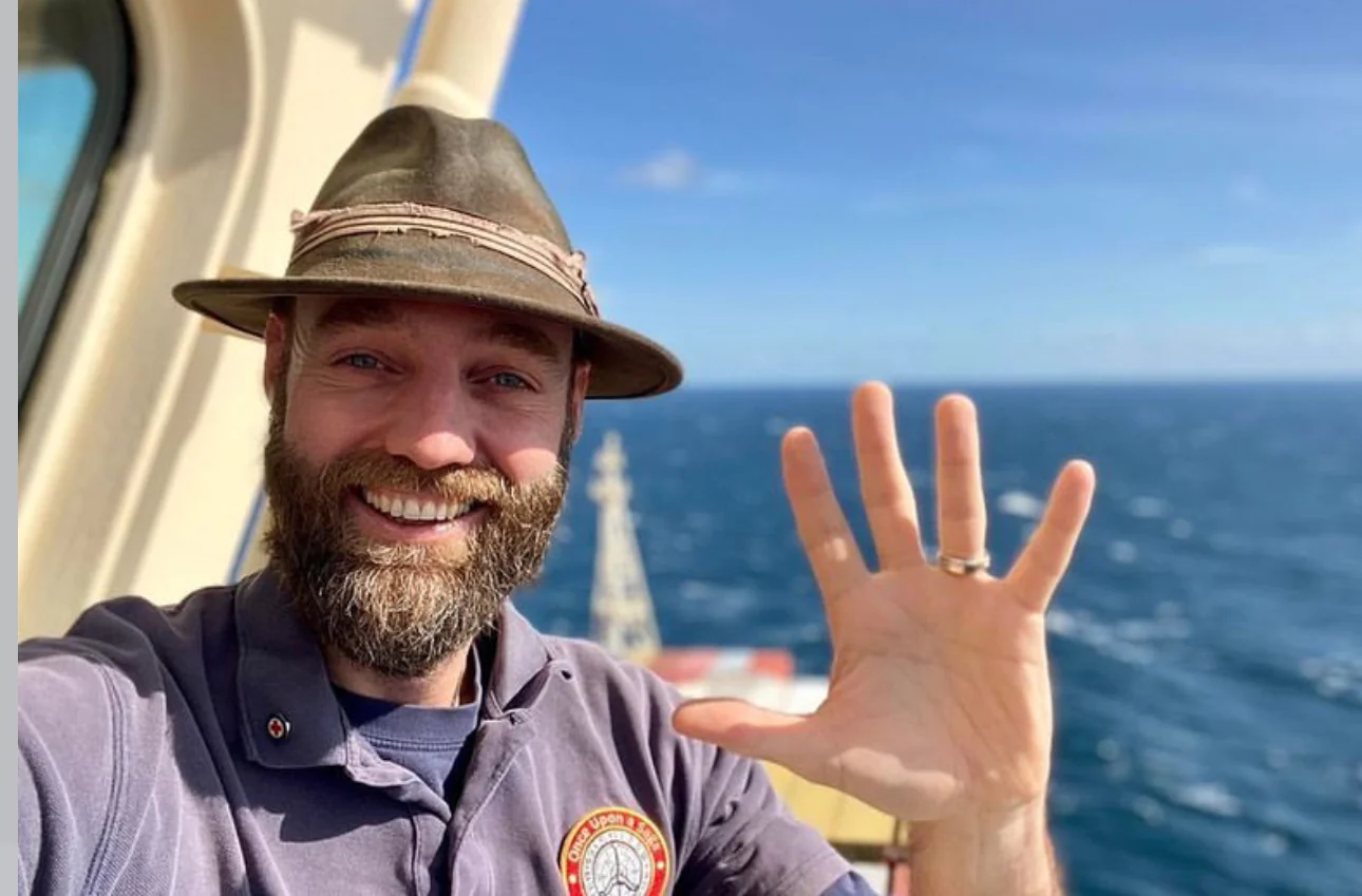 A picture of Torbjørn C. Pedersen, the first man who visited every country in the world without flying, waving on the boat. Ferrys and boats were one of the means of transport he would use to complete his journey of 10 years.
