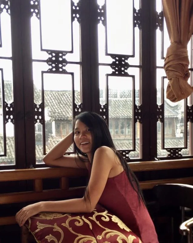 Smiling Sabrina Chunyan Zhang, a female solo traveller exploring the world on her Chinese passport